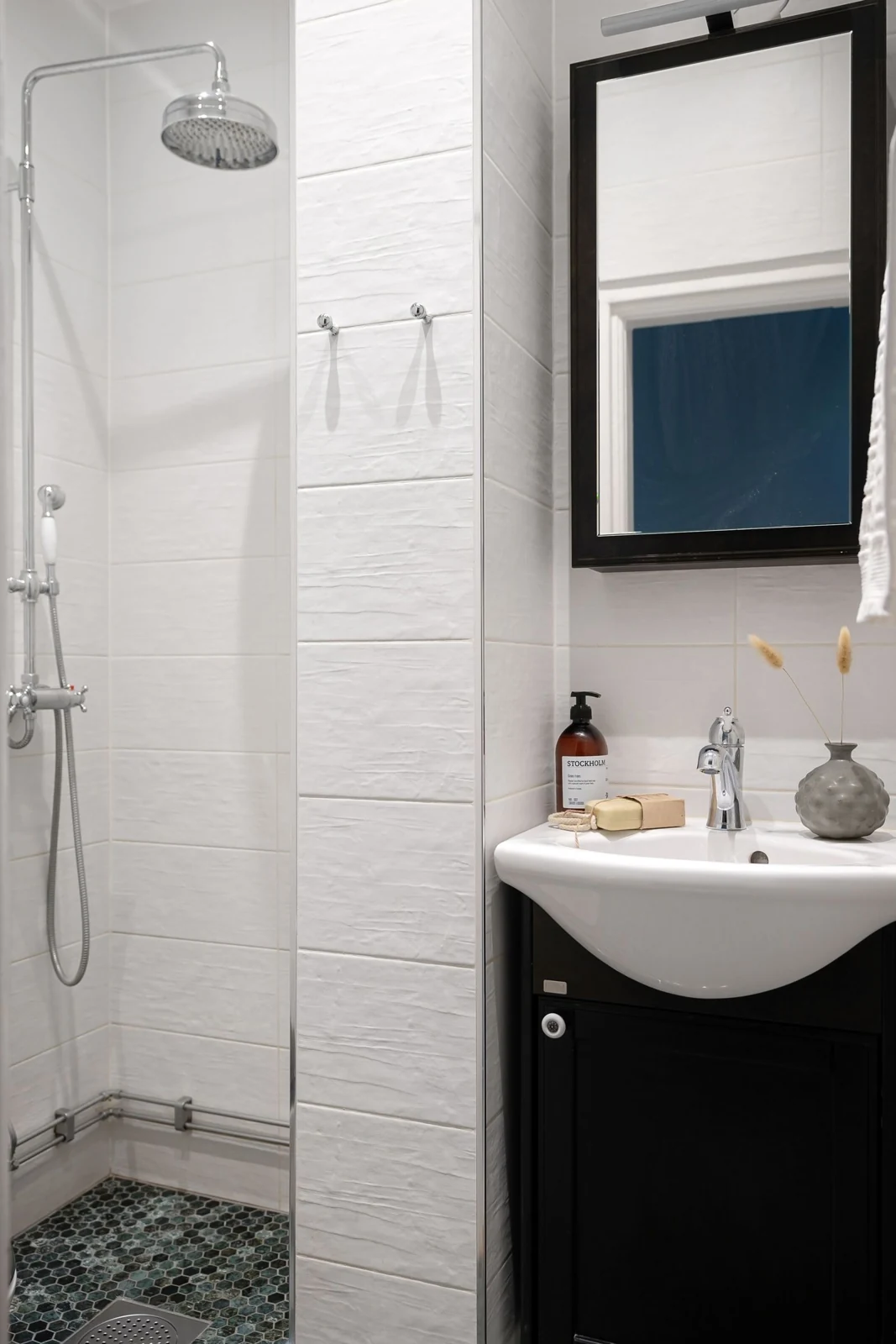 A sleek bathroom interior with a modern shower and elegant sink setup, perfect for contemporary homes