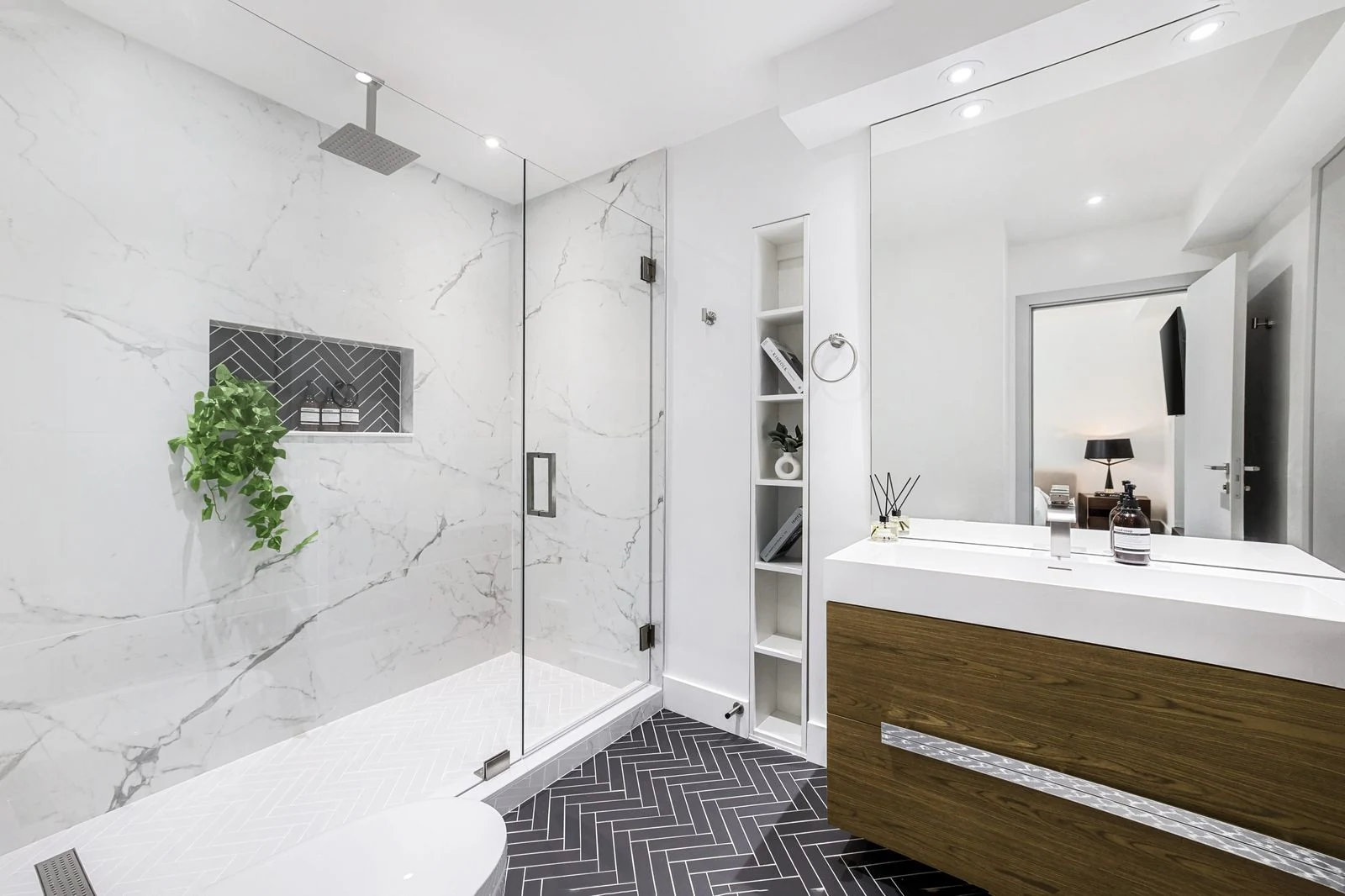 Elegant modern bathroom interior with a glass shower and marble walls