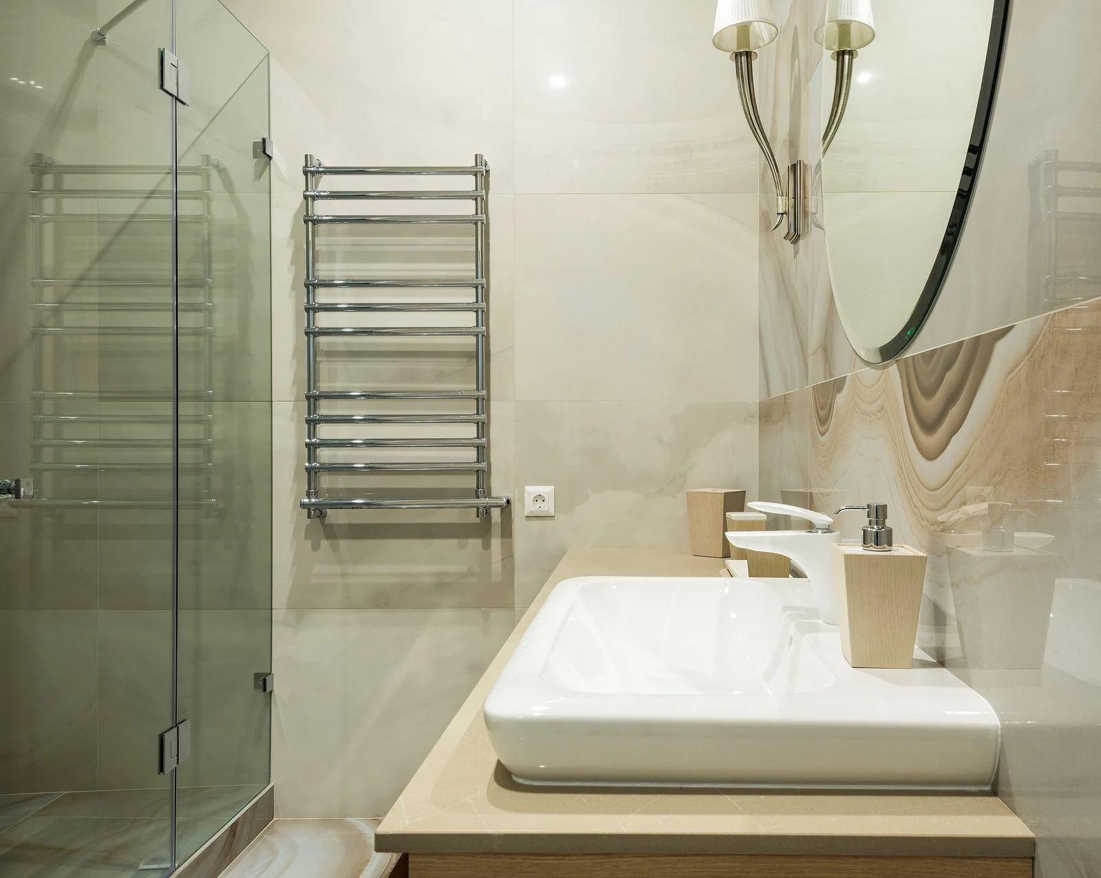 Contemporary bathroom with clean lines, featuring a glass shower, mirror, and sleek fixtures